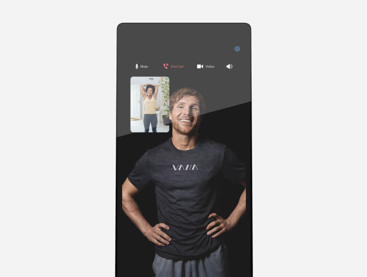 two woman doing workout with the VAHA mirror